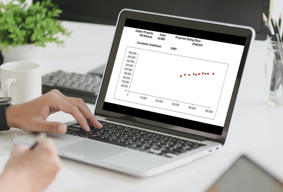 laptop with regression analysis graph, real estate investment analysis